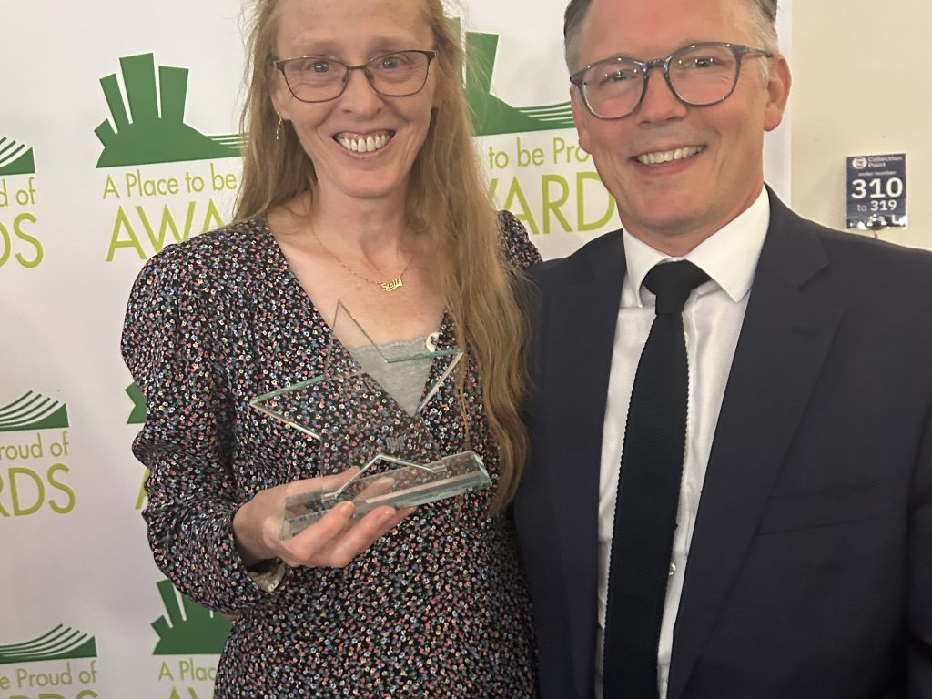Stella Gibbons pictured with her trophy, alongside Mark Henderson, Principal of QMC