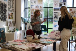 A QMC teacher discussing Art at QMC with visits on Open Evening