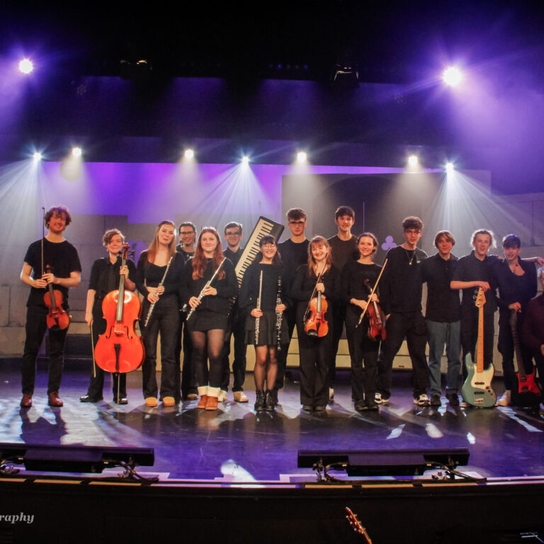 A group of QMC Music Students on stage
