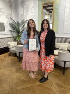 Hannah Boyle pictured with her Place To Be Proud Certificate, with Katie Harnett