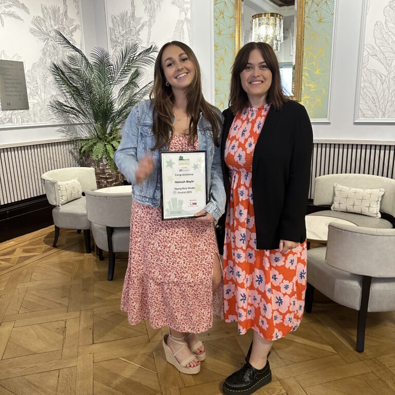 Hannah Boyle pictured with her Place To Be Proud Certificate, with Katie Harnett
