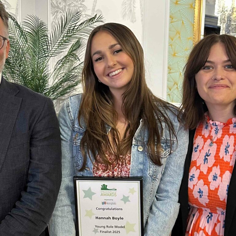 Hannah Boyle pictured with her Place To Be Proud Certificate, alongside Mark Henderson and Katie Harnett