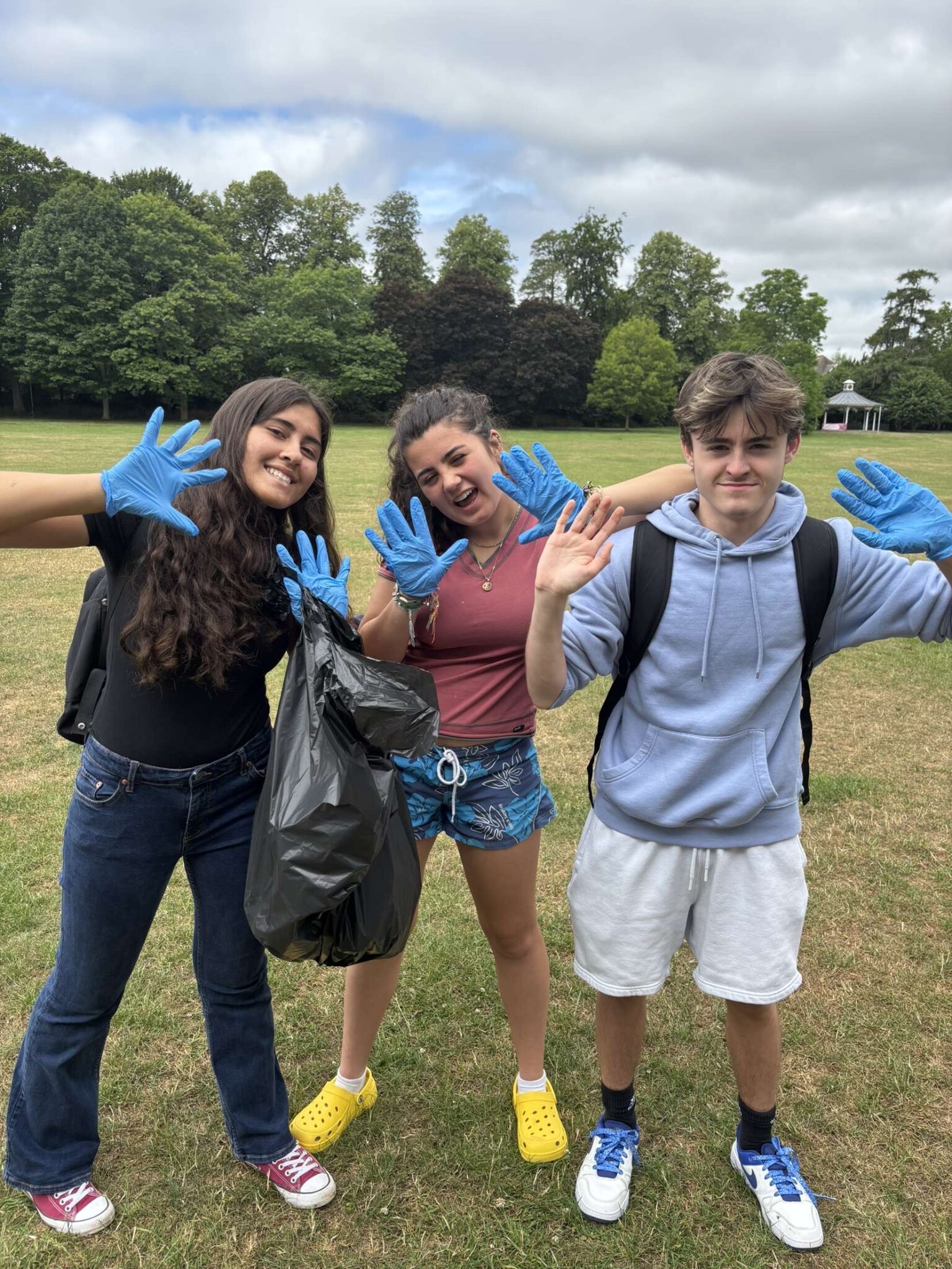 three people with rubbish in their hand