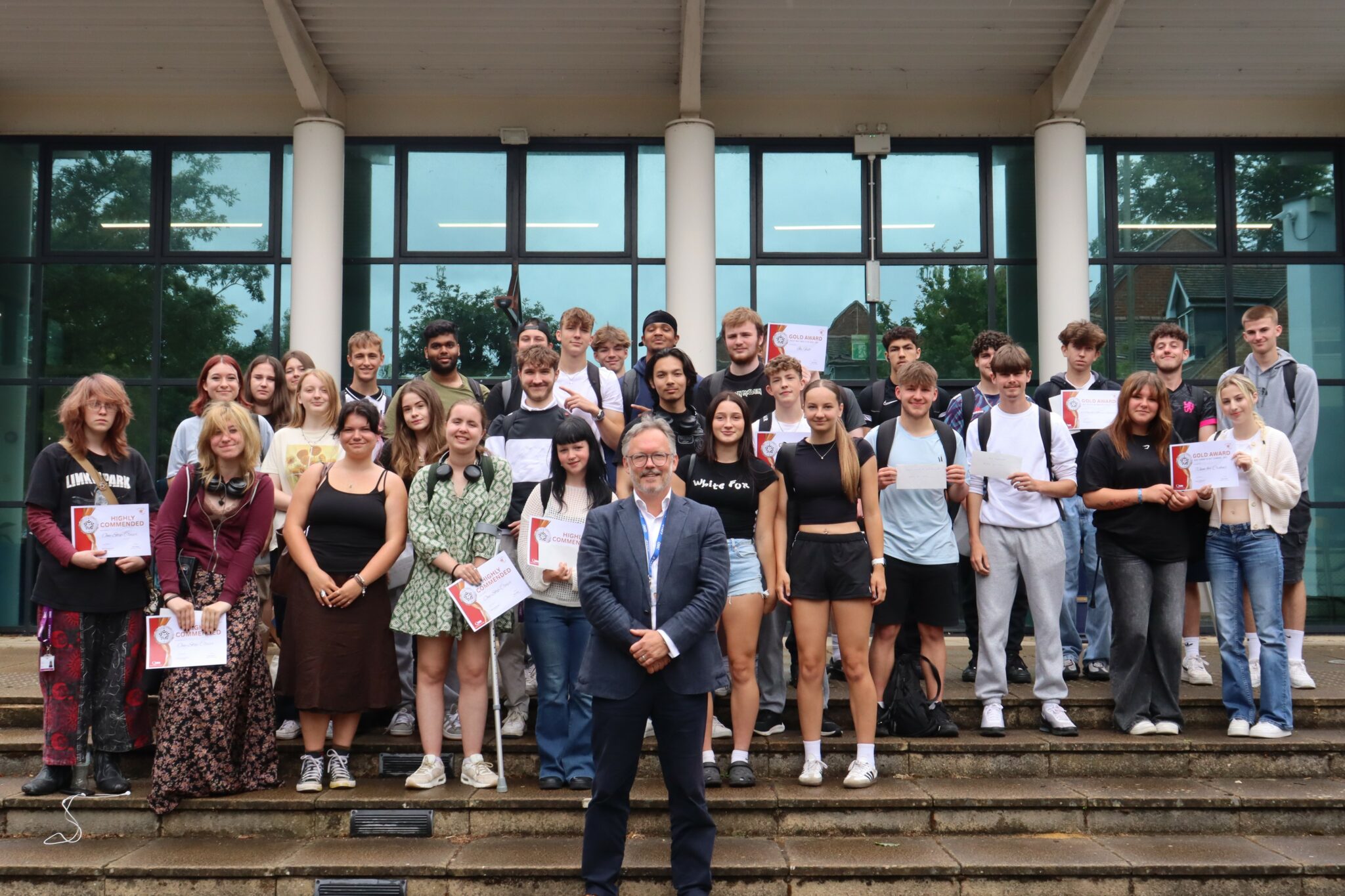 Group of people standing in front of hall.