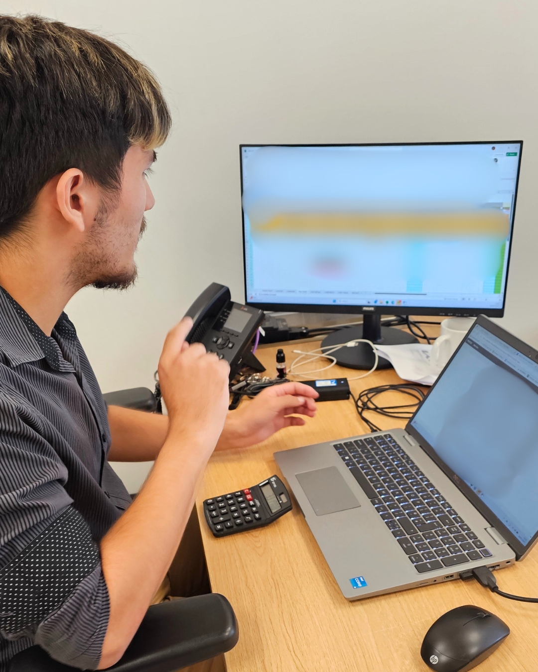 a person sitting at a desk in front of a computer