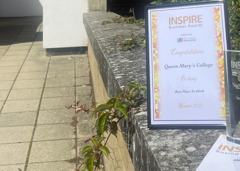a certificate in a frame and award on a ledge outside