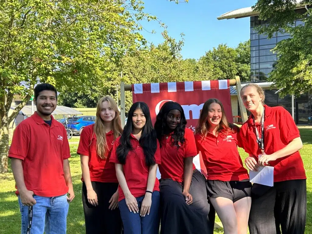 a group of people in red shirts posing for a picture