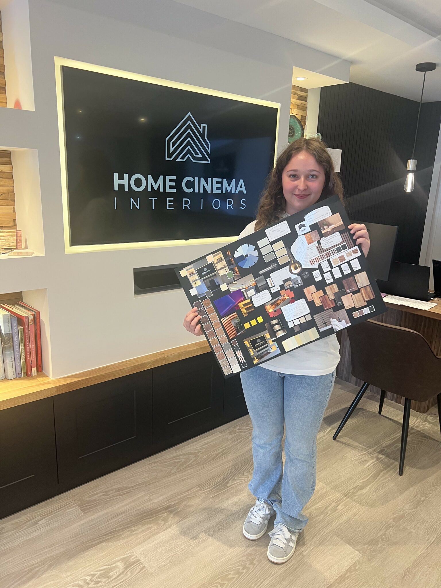 a person holding up a sign that says home cinema interiors