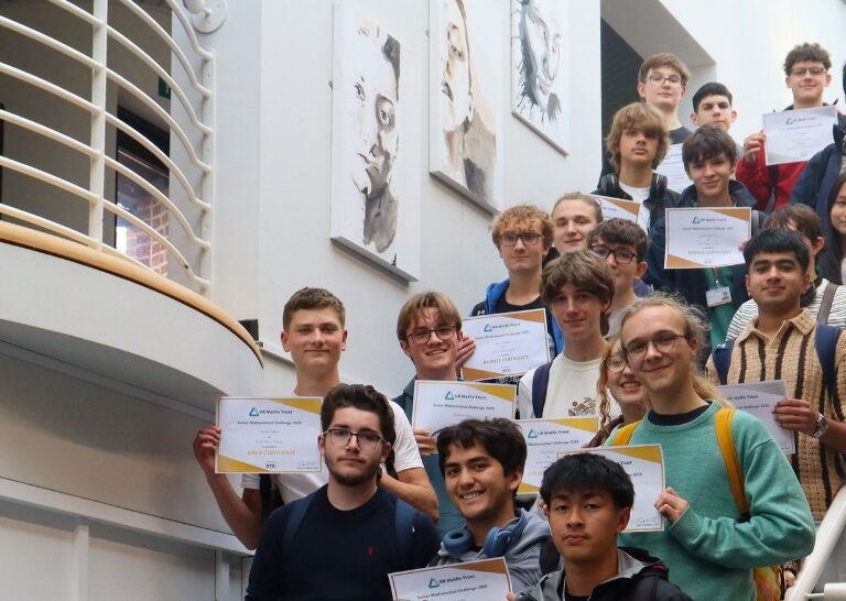 people standing on stairs holding up certificates