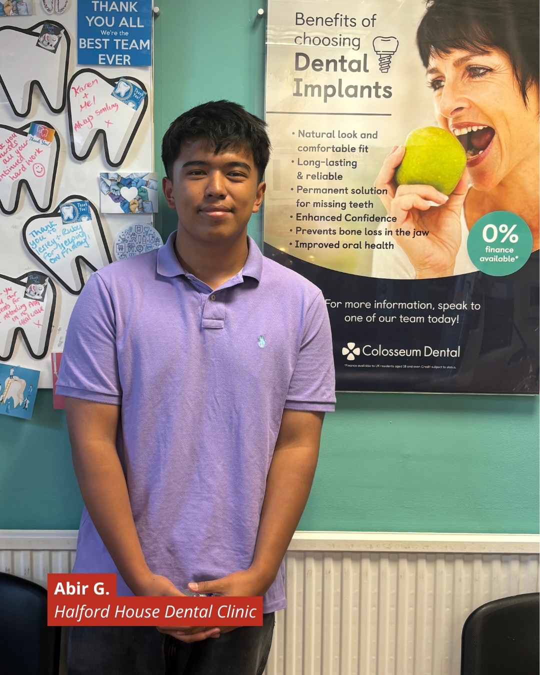 Young man in a lavender polo stands in a dental clinic beside a dental implants poster; bottom label reads Abir G. Halford House Dental Clinic.