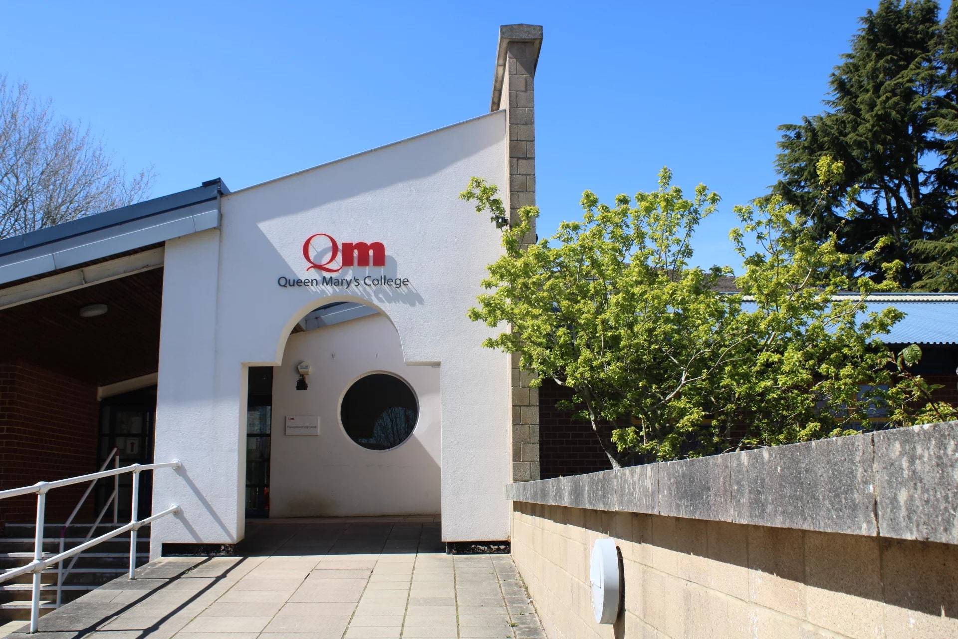 the entrance to a building with a red sign on it