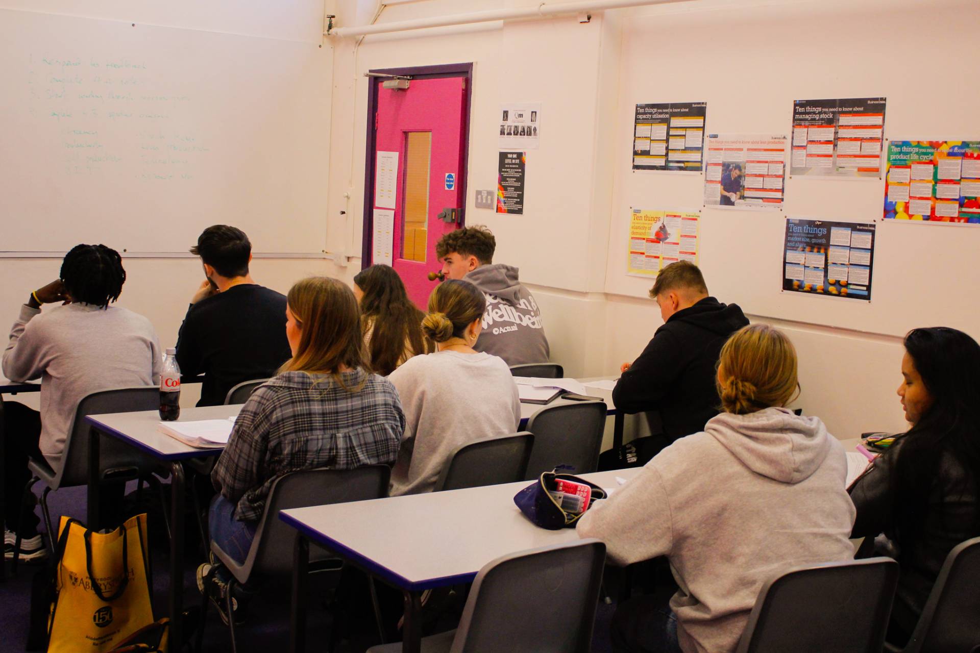 A group of students pictured in a classroom at Queen Mary's College.