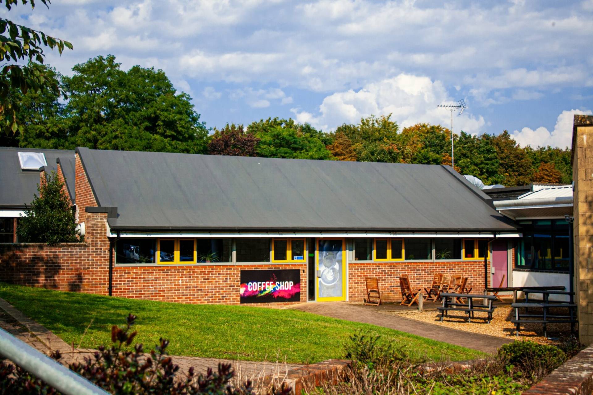 a building with a large grassy area in front of it