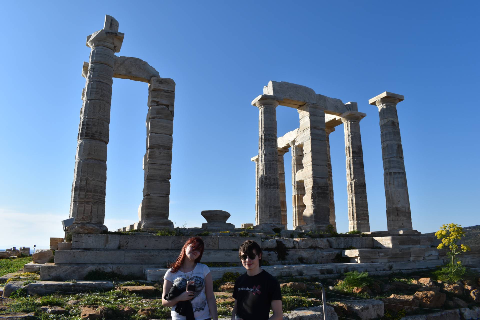 Two students standing in front of a Greek colosseum