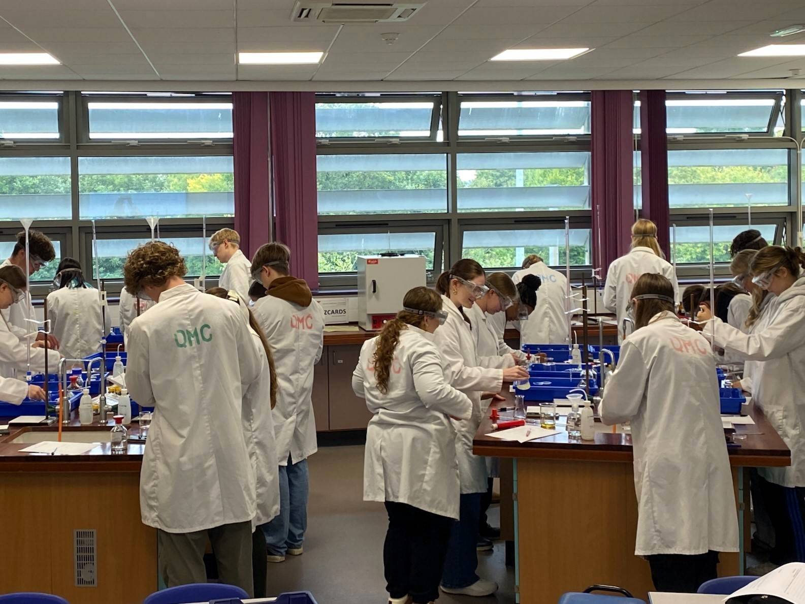 a group of people in lab coats working on something