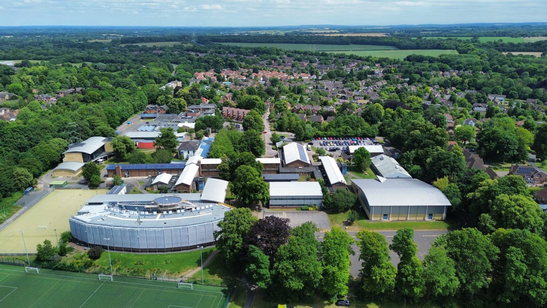 an aerial view of a college campus surrounded by trees