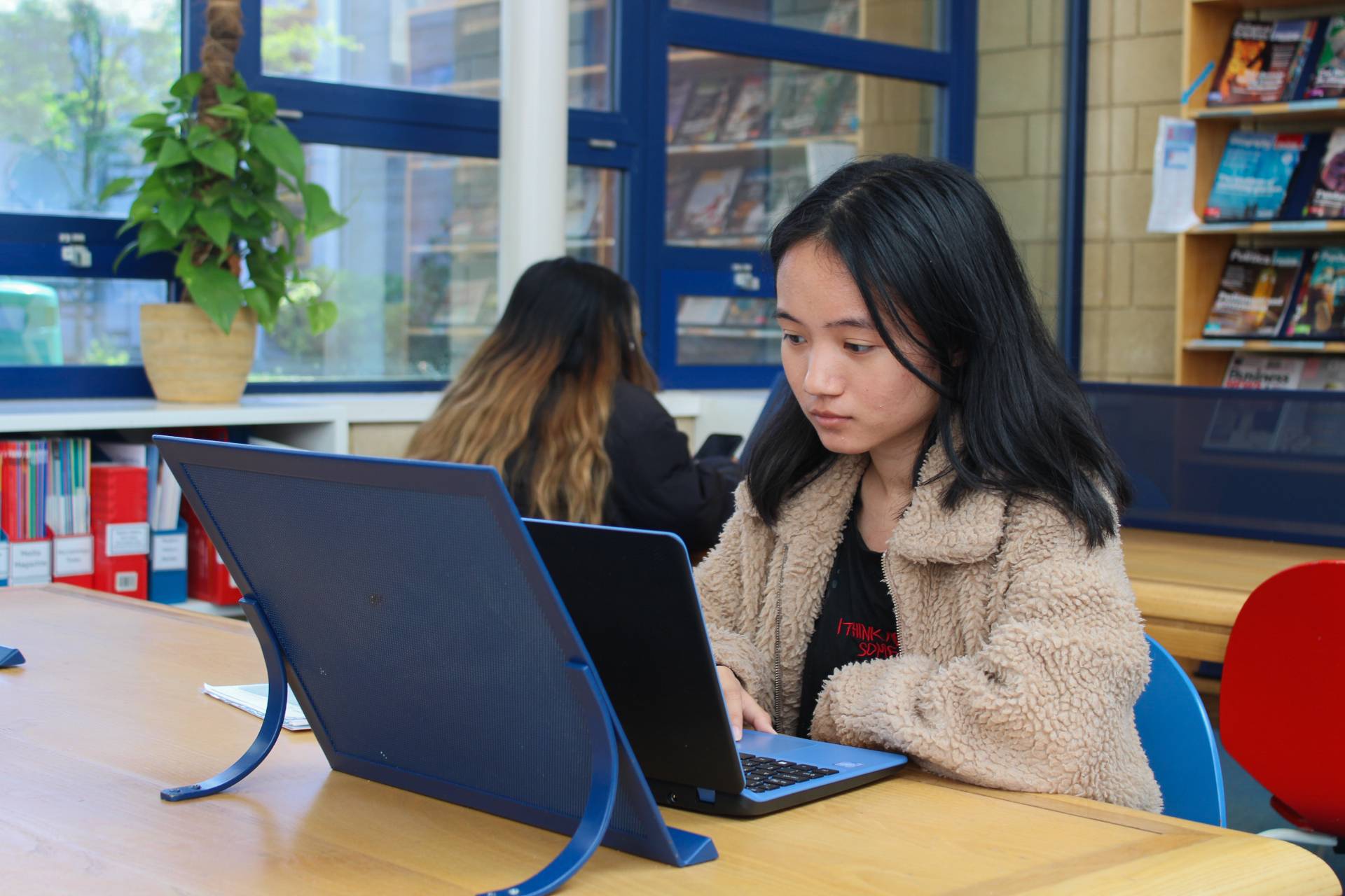 a person sitting at a table with a laptop