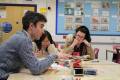 Politics teacher with student at QMC