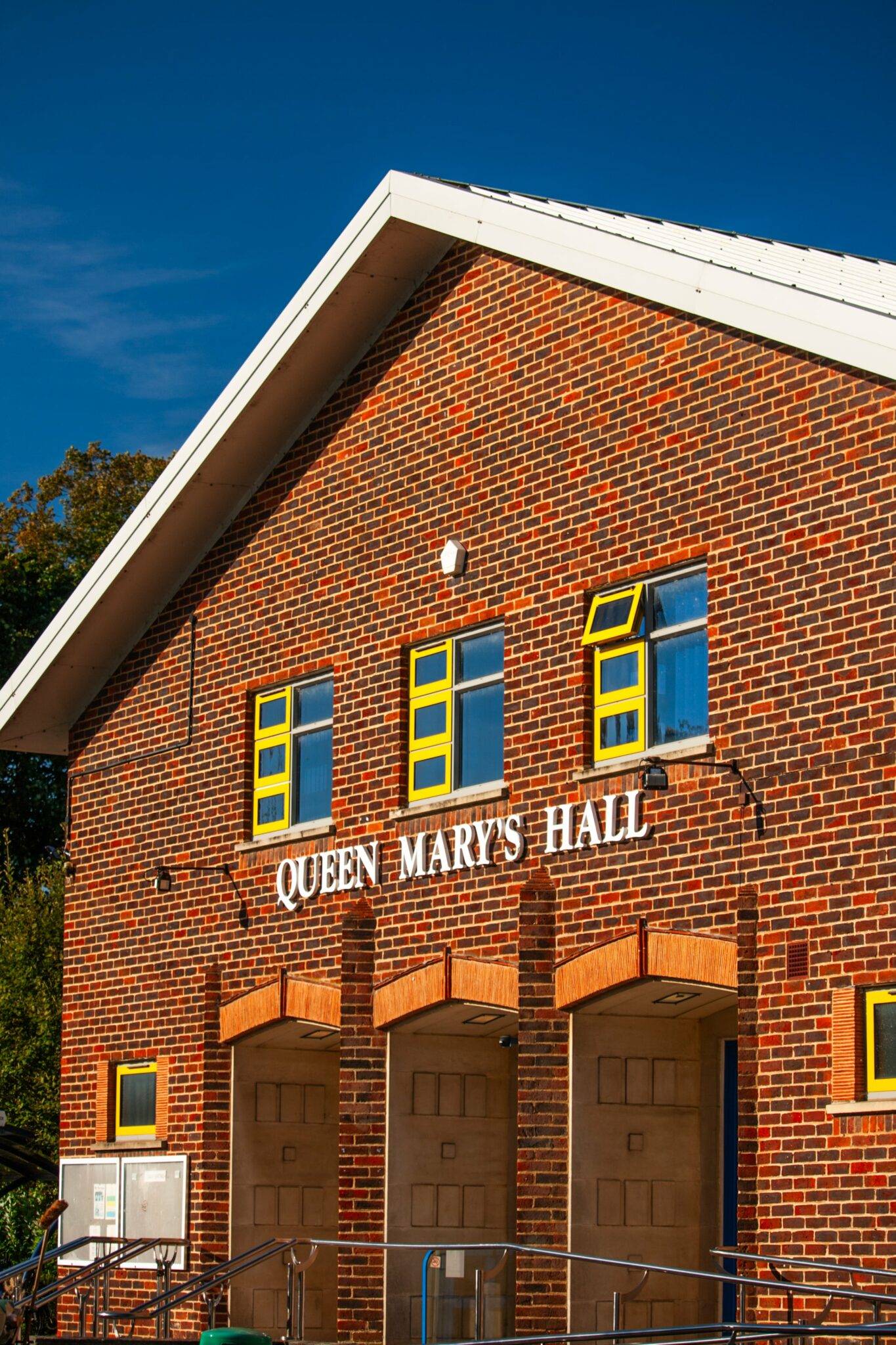 a brick building with the words queen mary hall on it