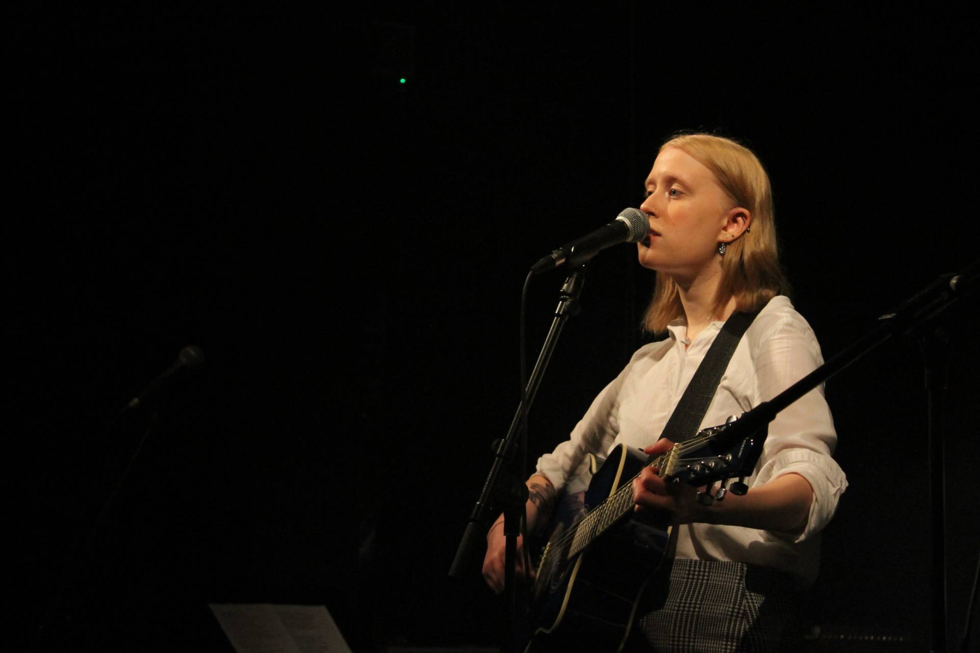 QMC student performing on her guitar